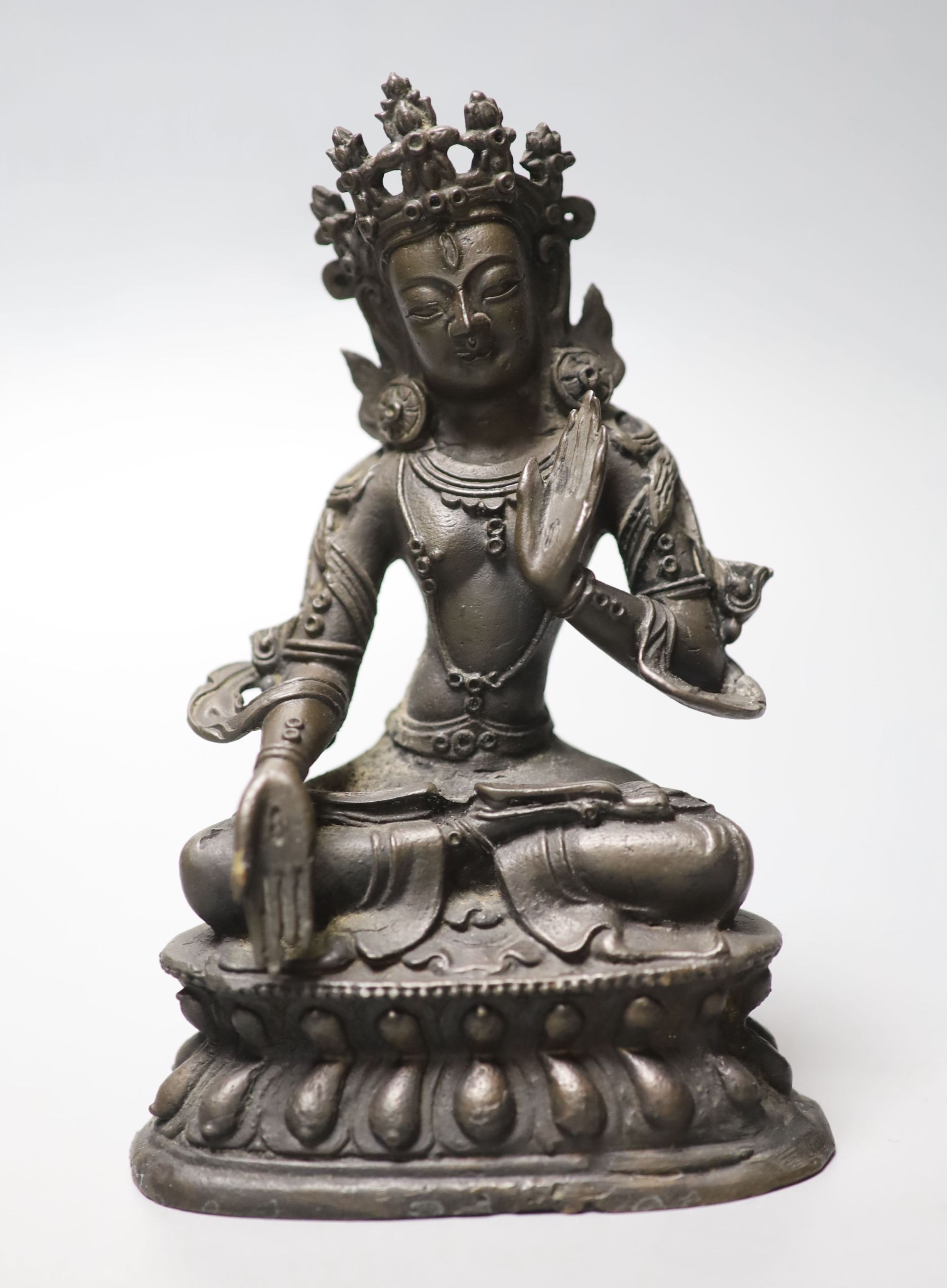 A Chinese or Sino-Tibetan bronze seated Buddha, possibly 18th century, height 16.5cm